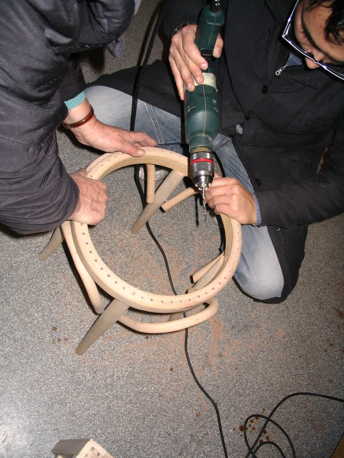 Dario drilling a bentwood chair during work in progress