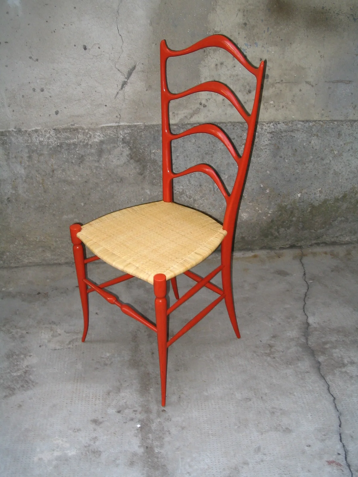 Contemporary red chair with woven seat