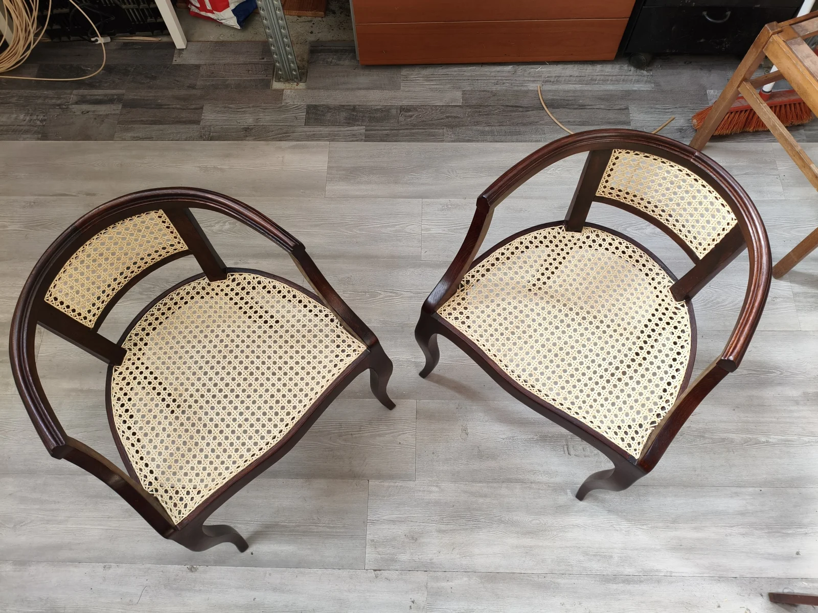 Two finished bentwood armchairs with woven seats
